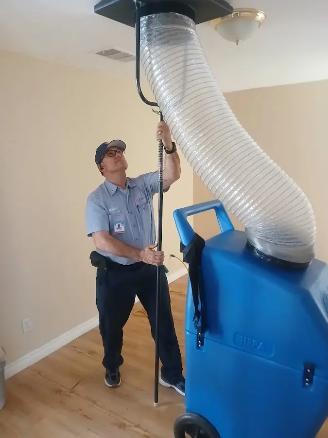 Furnace Tune-Up technician using HEPA equipment in Neenah